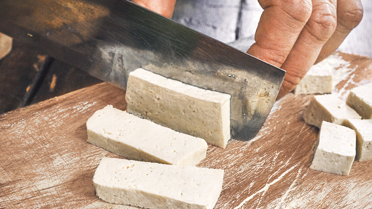 Cutting Tofu on Wooden Cutting Board